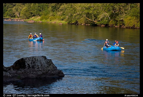 Two Rafts passing boulder, McKenzie river. Oregon, USA