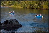 Two Rafts passing boulder, McKenzie river. Oregon, USA