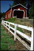 Fence and red covered bridge, Willamette Valley. Oregon, USA