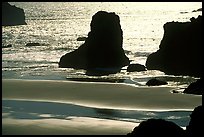 Rocks, water reflections, and beach, late afternoon. Bandon, Oregon, USA