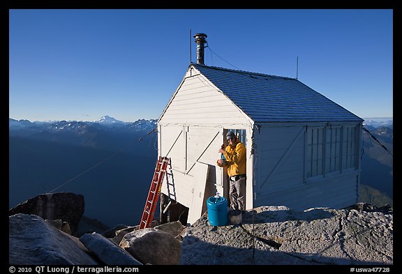 Man standing in doorway of Hidden Lake lookout. Washington (color)