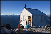 Man standing in doorway of Hidden Lake lookout. Washington ( color)