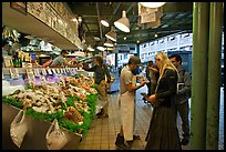 Countermen offer fish samples, Pike Place Market. Seattle, Washington