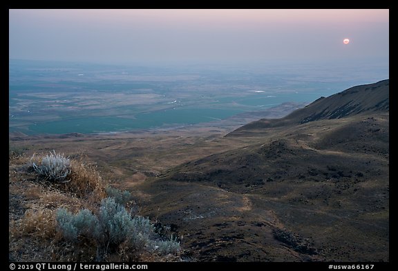 Sun rising in haze over Saddle Mountain, Hanford Reach National Monument. Washington (color)