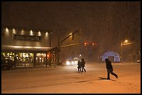 People cross street in night blizzard. Jackson, Wyoming, USA