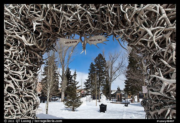 Town Square framed by Antler Arch in winter. Jackson, Wyoming, USA