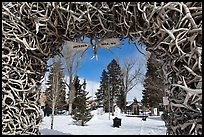 Town Square framed by Antler Arch in winter. Jackson, Wyoming, USA