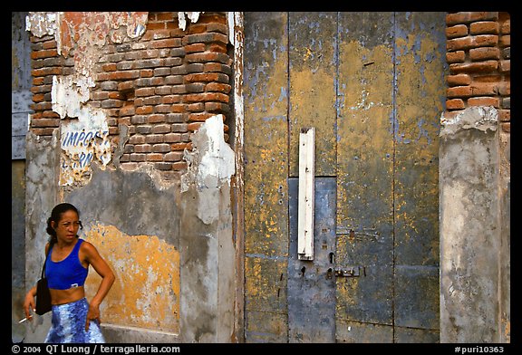 Woman in front of a decaying brick wall, Ponce. Puerto Rico (color)