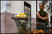 Man peeling oranges to make a drink, drunk from the fruit itself, Ponce. Puerto Rico ( color)