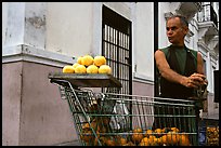 Man peeling oranges to make a drink, drunk from the fruit itself, Ponce. Puerto Rico