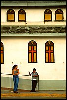 Woman and boy talking besides a church, La Parguera. Puerto Rico