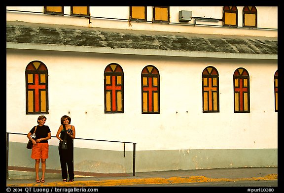 Two women standing in front of a church, La Parguera. Puerto Rico (color)