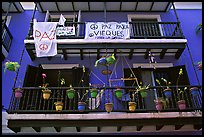 Facade of house painted in blue with pots, balconies and anti-war signs. San Juan, Puerto Rico ( color)