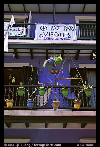 Facade of house painted in blue with plant pots and balconies. San Juan, Puerto Rico (color)