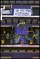 Facade of house painted in blue with plant pots and balconies. San Juan, Puerto Rico ( color)