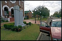 African-American man sitting in car looking at Martin Luther King memorial. Selma, Alabama, USA (color)