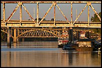 Bridges over Arkansas River, submarine and riverboats at sunrise. Little Rock, Arkansas, USA (color)