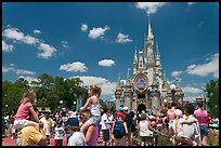 Girls on fathers shoulders, Cinderella Castle. Orlando, Florida, USA