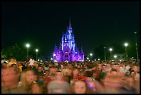 Crowds on Main Street with castle in the back at night. Orlando, Florida, USA (color)