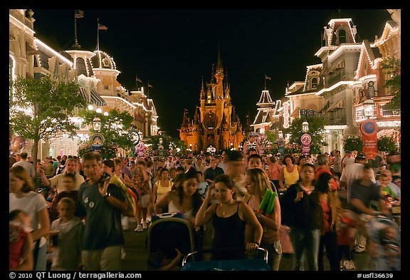 Main Street at night with crowds and castle. Orlando, Florida, USA (color)