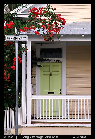 Pastel-colored house, tropical flowers, street sign. Key West, Florida, USA (color)