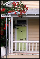 Pastel-colored house, tropical flowers, street sign. Key West, Florida, USA (color)