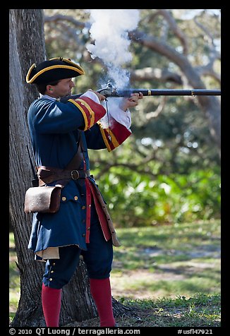 Man in period costume fires smooth bore musket, Fort Matanzas National Monument. St Augustine, Florida, USA (color)