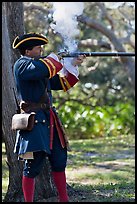 Man in period costume fires smooth bore musket, Fort Matanzas National Monument. St Augustine, Florida, USA