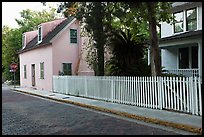 White picket fence and houses on cobblestone street. St Augustine, Florida, USA