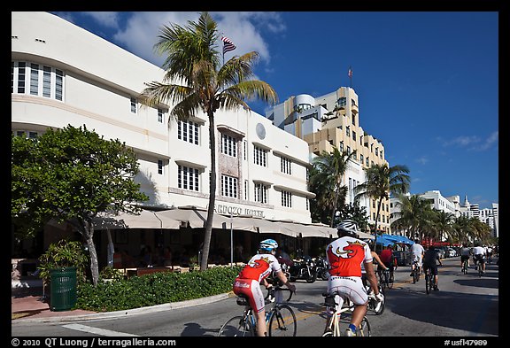 Cyclists passing Art Deco hotels, Miami Beach. Florida, USA