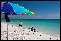 Beach with unbrella, children playing and woman strolling,. The Keys, Florida, USA ( color)