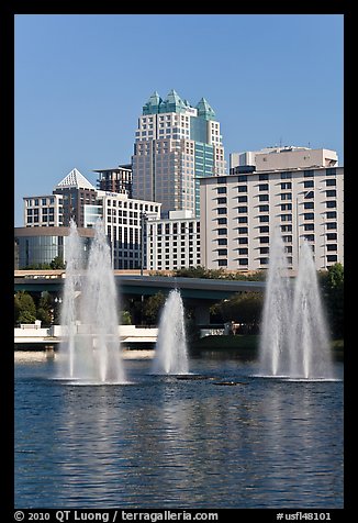 Fountains and downtown high-rises from Lake Lucerne. Orlando, Florida, USA