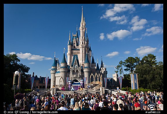 Iconic Cindarella Castle with tourists gathered for show, Magic Kingdom. Orlando, Florida, USA (color)