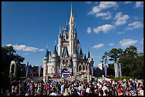 Iconic Cindarella Castle with tourists gathered for show, Magic Kingdom. Orlando, Florida, USA (color)