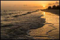 Beach with people in the distance at sunset, Sanibel Island. Florida, USA (color)