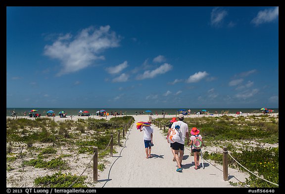 Family walking out to Bowman Beach, Sanibel Island. Florida, USA