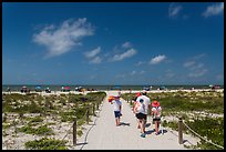 Family walking out to Bowman Beach, Sanibel Island. Florida, USA (color)