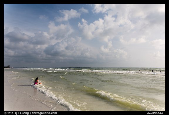 Woman sitting in water, Fort De Soto beach. Florida, USA