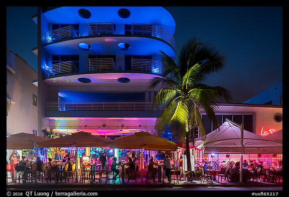 Restaurant tables and Art Deco buildings at night, Miami Beach. Florida, USA (color)