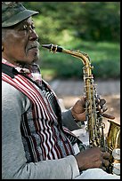 African-American musician with saxophone in square. Savannah, Georgia, USA (color)
