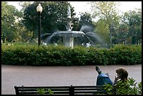 Woman reading in front of Forsyth Park Fountain. Savannah, Georgia, USA