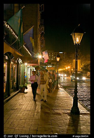 People on sidewalk of River Street by night. Savannah, Georgia, USA (color)