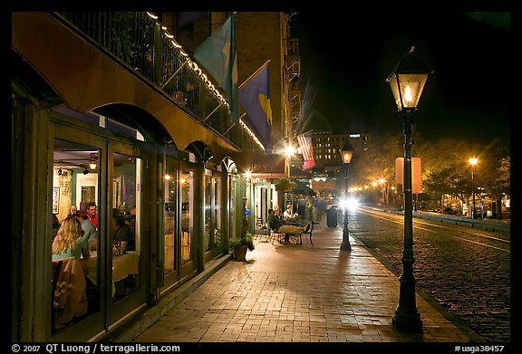 Restaurant, lamps, and sidewalk of River Street by night. Savannah, Georgia, USA