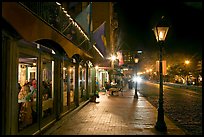 Restaurant, lamps, and sidewalk of River Street by night. Savannah, Georgia, USA ( color)