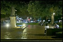 Square by night with people sitting on benches. Savannah, Georgia, USA (color)