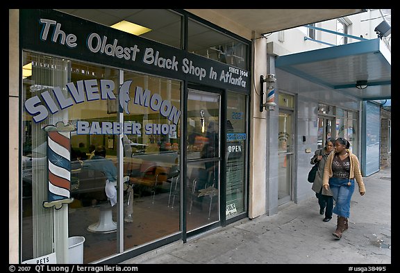 Women walking in front of oldest black shop in Atlanta. Atlanta, Georgia, USA (color)