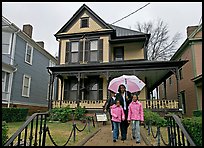 African American family with umbrella in front of Birth Home of Martin Luther King Jr. Atlanta, Georgia, USA (color)