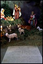 Tombstone of a French priest, and figures inside a replica of the Lourdes grotto, church Saint-Martin-de-Tours, Saint Martinville. Louisiana, USA