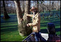 Bayou guide of French descent retriving net,  Lake Martin. Louisiana, USA