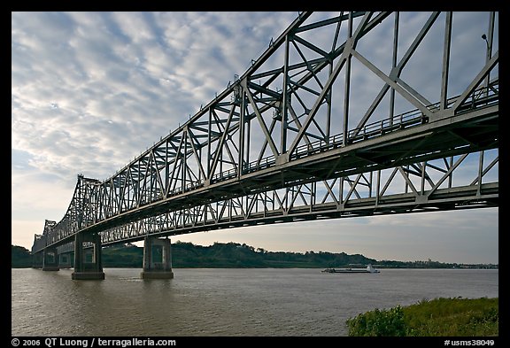 Barge on the Mississippi River approaching bridges. Natchez, Mississippi, USA (color)